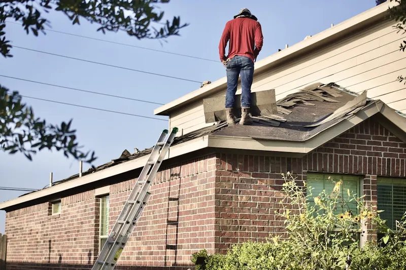 Professional roofer working on a residential roof in Lacy-Lakeview